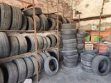 many tires stacked on a shelf in a warehouse