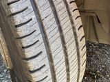 a tire that is sitting on the ground next to a car