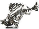 skeleton of a fish on a white surface with a white background