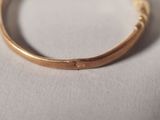 a close up of a gold ring on a white surface