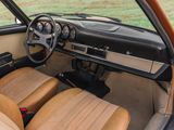 dashboard of a car with tan leather seats and dashboard controls
