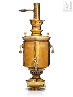 an antique brass urn on a pedestal with a wooden handle