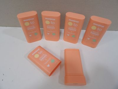six sunscreen sunscreen lotion bottles sitting on a table