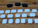 a lot of white and black buttons on a wooden table