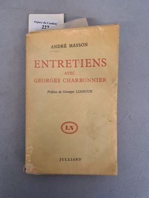 an old book sitting on top of a table next to a piece of paper