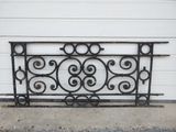 an image of a wrought iron bed frame sitting on the side of a building