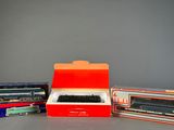 three boxed trains sitting next to each other on a table