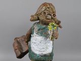 an image of a statue of a woman with a flower in her hand