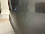 a close up of a car ' s front bumper with a sticker on it