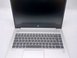 an open laptop computer sitting on top of a white table