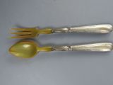pair of silver plated spoons and a fork on a table