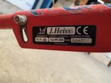 a close up of a red bike with a sticker on it