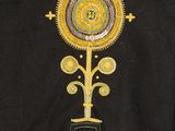 a close up of a black shirt with a yellow and blue design