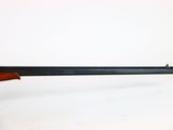 a rifle with a wooden barrel on a white background