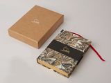 the box is brown and white with a red ribbon around it