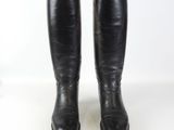 pair of black leather riding boots on a white background
