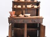 a small wooden cabinet with a shelf and a bowl on it