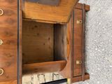 a wooden cabinet with a mirror on top of it