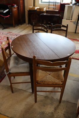 a table and chairs in a living room with a rug