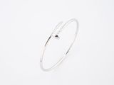 a close up of a silver bracelet on a white background