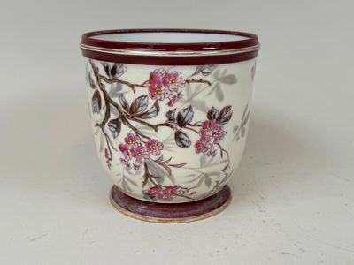 a close up of a vase with a flower design on it