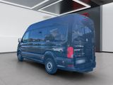 the rear end of a blue van parked in a garage