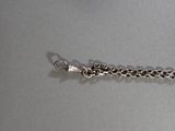 a silver chain that is attached to a silver bracelet