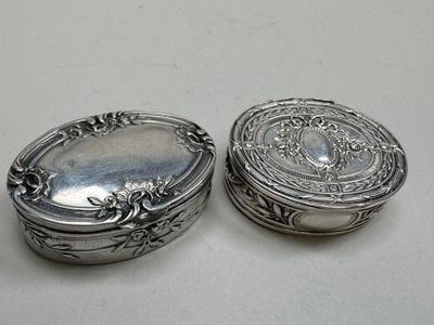 pair of antique silver plated boxes on a white surface