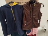 three jackets on a rack in front of a cardboard box