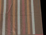 an image of a brown table cloth with multi colored stripes on it