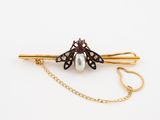 an image of a pearl and diamond butterfly broochle with a gold chain
