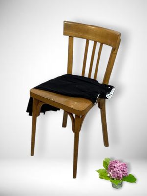 a wooden chair with a black cushion on top of it
