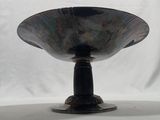 an image of a metal bowl on a stand against a white backdrop