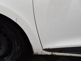 a close up of a white car with black rims