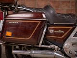 a motorcycle that is parked in front of a brick wall