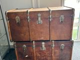 four trunks stacked on top of each other in a room
