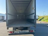 the back end of a truck with the door open in a parking lot