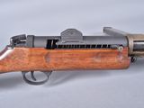 a close up of a rifle on a table with a white background