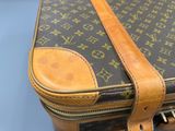 a close up of a brown and black louis vuitton bag