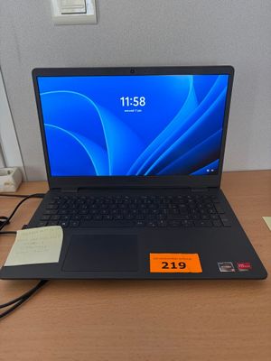 a laptop computer sitting on a desk with a price tag on it