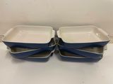 a pair of blue and white casserole dishes sitting on a table