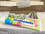 un tube de dentifrice posé sur une boîte de dentifrice