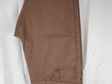 brown pants hanging on a hanger on a white sheet