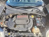 a car engine with its hood open on the street