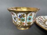 a small cup and saucer sitting on a table