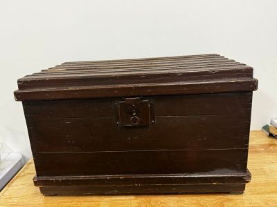 an old wooden chest sitting on top of a wooden table