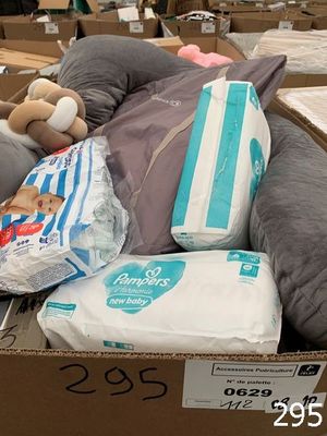 a cardboard box full of diapers and a stuffed animal
