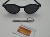 black sunglasses and a keychain are sitting on a table
