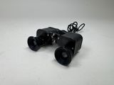 an image of a pair of binoculars sitting on top of a table