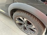 a close up of a car ' s tire on the street